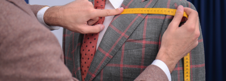 Un homme mesure un costume.